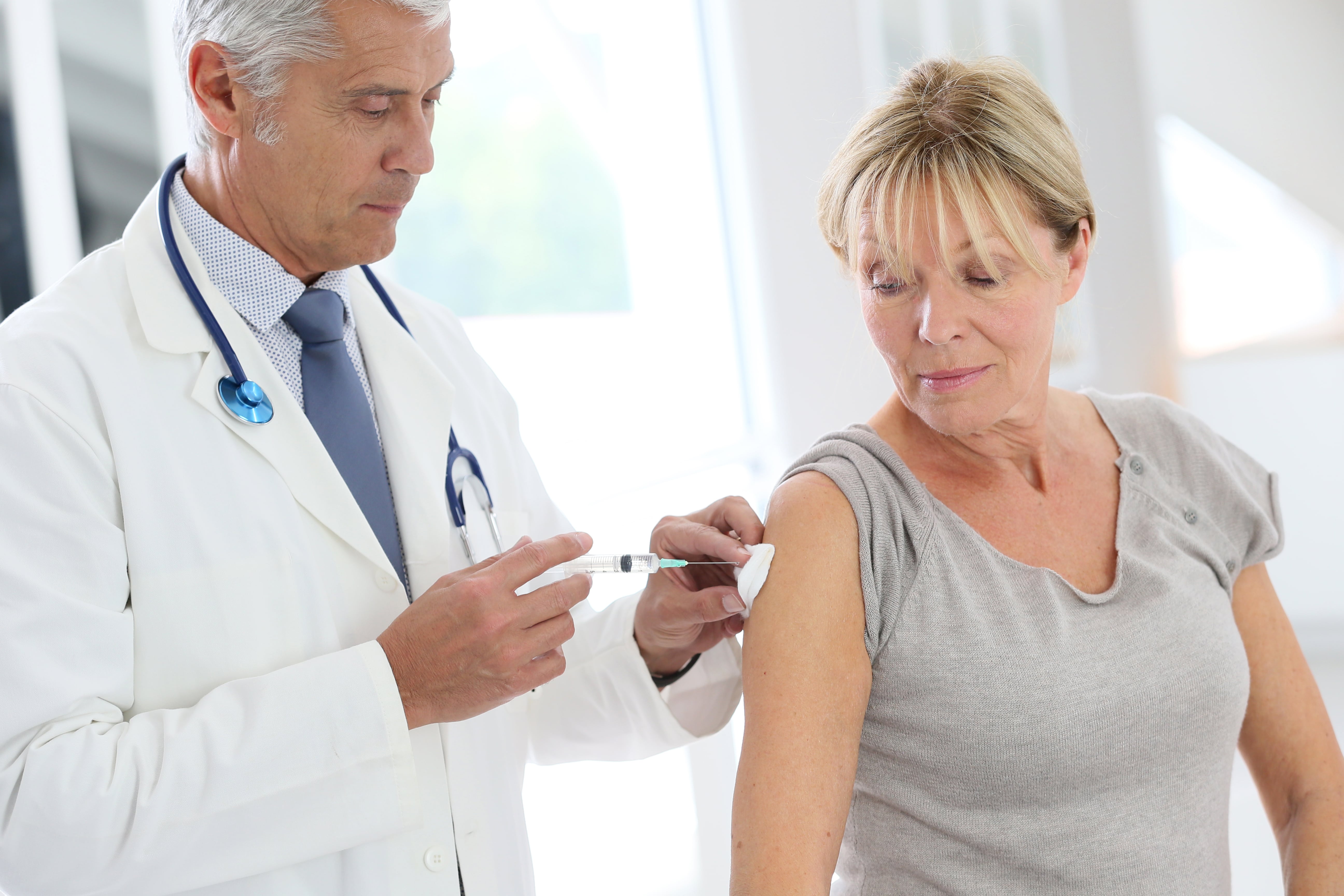 middle-aged woman receiving a shot